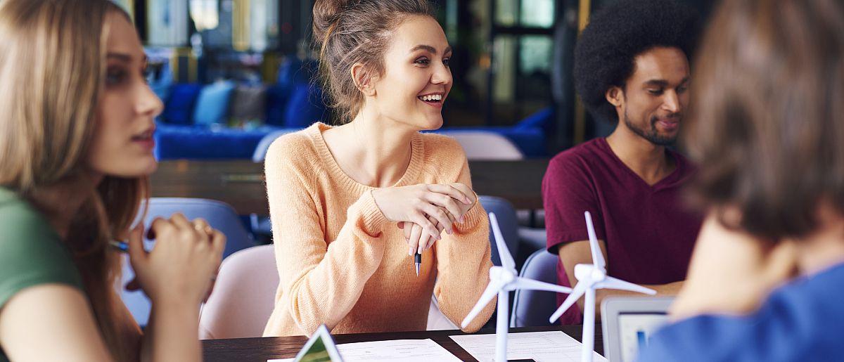 Young coworkers talking at conference table